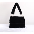 Detail of a fluffy black faux fur handbag with a thick shoulder strap and gold hardware - Black