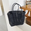 Handmade woven black straw tote bag with cutout design for vacation and beach use - Black