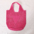 Fuchsia woven straw tote bag with cutout mesh design and triangular knit pattern - Rose Red