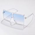 Detail of oversized clear square sunglasses featuring blue gradient lenses and modern frame - Transparent Blue