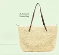 Close-up of handmade straw tote bag with cream woven texture and brown leather handles - Beige