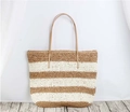 Detail of the woven texture and contrast stripes on a large straw shoulder beach bag - Brown White Striped