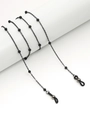 Detail of black beaded metal eyewear chain wrapped around a white cylinder prop - Black Bead Style (GL11361111111)
