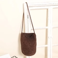 Dark brown straw woven bucket bag featuring cross-stitch texture and shoulder strap - Brown