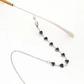 Detailed close-up of a silver-toned eyewear chain featuring black heart-shaped glass beads - Black and Silver