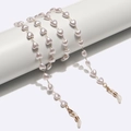 Golden heart pearl glasses chain and mask strap shown on a white minimalist display stand - Gold with Creamy White Heart Pearl