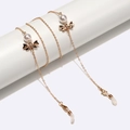 Catenina per occhiali dorata con perle bianche e raffinati dettagli a fiocco - Fiocco Dorato con Perla
