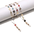 Golden eyewear chains with colorful crystals and rose-engraved heart charms on white display - Gold (Colorful Stone)