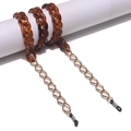 Amber acrylic and gold hexagonal metal eyeglasses chain on white display stand - Amber Gold Stitched Style