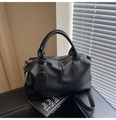 Detail of black lychee grain leather Boston bag with gold hardware and shoulder strap - Litchi Texture Style / Black