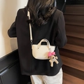 Dettaglio mini borsa a secchiello bianca con grana litchi e ciondolo a cucciolo - Senza Ciondolo / Bianco