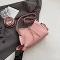 Pink lychee texture leather handbag with adjustable strap and decorative side pockets - Pink