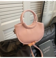 Pink pleated bucket bag detail showing the round top handle and long shoulder strap - Pink