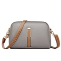 Chic grey shell-shaped crossbody bag with brown leather straps and gold hardware - Gray