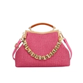 Pink woven handbag with gold chain detail, brown leather handle, and crossbody strap - Rose Red