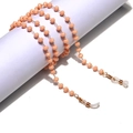 Detail of peach pink crystal beaded glasses chain with golden links and silicone loops - Nude Pink