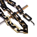 Detail of tortoiseshell resin links and metal rings on glasses chain with lobster clasp - Gold + Black