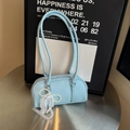 Light blue lychee texture leather bag with pearl and lace bow charm on metal table - Light Blue (With Pearl Lace Pendant)