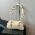 Creamy white lychee leather cylinder shoulder bag with silver double zipper and long handles - Cream