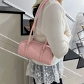 Pink lychee grain leather Boston bag shown on model with casual knit cardigan and lace - Pink