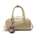 Chic beige boston handbag with pebbled texture and cute plush doll charm - Yellow