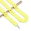 Detail of yellow acrylic link glasses chain with clear silicone anti-slip ends on a book - Bright Yellow