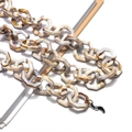 Macro detail of marble textured acrylic glasses chain with hexagonal links and silicone loops - Two-tone Shell (Caramel Cream)