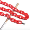 Detail of red acrylic eyewear chain with black rubber loops and shiny link texture - Red