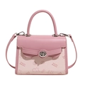 Detailed view of pink Kelly bag with cute cartoon prints and silver rotating metal lock - Pink