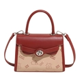 Detail of red and cream embossed handbag featuring bear prints and silver turn-lock closure - Red