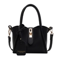 Elegant black lychee leather handbag with golden twist lock and removable strap - Black