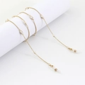 Catenella per occhiali dorata con perle ovali su supporto bianco in stile minimalista - Oro