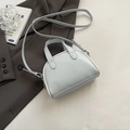 Light blue semi-circular crossbody bag with dual handles and white contrast piping detail - Blue