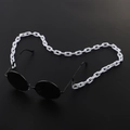Black round sunglasses with white chunky acrylic link chain on a dark background - White