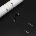 Detail of beaded eyewear chain with gold butterfly charms, black tassels and ceramic beads - Black
