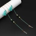 Detail of bohemian glasses chain with mint green tassels and vintage floral beads - Green