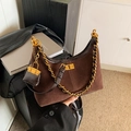 Brown suede hobo bag with chunky gold chain and mini pouch charm in stylish display - Coffee
