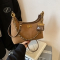 Brown suede saddle bag with gold chain strap and mini bag charm for women's commuting - Brown