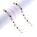 Elegant gold glasses chain with white pearls and black faceted beads on white stand - Gold Pearl Crystal Style