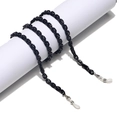 Detail of slim black acrylic eyewear chain with non-slip silicone loops on a white pedestal - Black