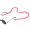 Macro detail of peach pink acrylic eyeglass chain in a heart shape on white background - 1 Rose Red