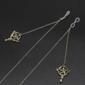 Golden metal eyewear chain with star wand charms and non-slip silicone loops on black base - Star Magic Wand Pendant Style / Gold