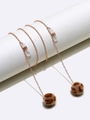 Golden metal eyewear chain featuring leopard print pom-poms on white display stand - Gold Leopard Hairball Style