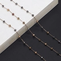 Minimalist handmade beaded eyeglass chain with multicolor faceted metal beads on white book - Multi-color Beaded Gold Chain (GL725)