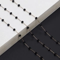 Elegant gold chain eyewear strap with faceted black crystal beads on a bicolor background - Gold Black Bead
