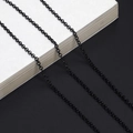 Detail of matte black round link chain for eyeglasses with sleek metallic finish - Black