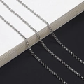 Macro detail of silver rolo chain links with polished finish for eyewear and jewelry - Silver