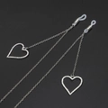 Elegant silver eyewear chain with rhinestone heart pendants on a textured black background - Silver (GL610)