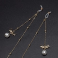 Catena per occhiali dorata con fiocchi in metallo e ciondoli di perle bianche eleganti - Stile Perla Con Fiocco Oro (GL573)