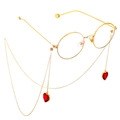 Detail van de gouden brillenketting met rode hartkristallen aan een ronde bril - Rood